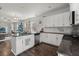 Open-concept kitchen with granite countertops, white cabinets, stainless steel appliances, and hardwood flooring at 546 Alderly Dr, Moncks Corner, SC 29461