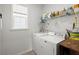 Functional laundry room featuring a washer, dryer, and storage shelves at 546 Alderly Dr, Moncks Corner, SC 29461