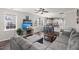 Open-concept living room and kitchen with large windows, modern TV, and a cozy gray sectional at 546 Alderly Dr, Moncks Corner, SC 29461