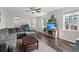 Bright living room with comfortable gray sectional, ceiling fan, and a modern entertainment center at 546 Alderly Dr, Moncks Corner, SC 29461