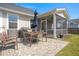 Cozy patio with outdoor dining set, grill, and a screened-in porch, perfect for entertaining at 546 Alderly Dr, Moncks Corner, SC 29461