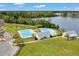 Aerial view of a community pool and playground near a lake, surrounded by lush trees and open green space at 546 Alderly Dr, Moncks Corner, SC 29461