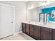Bathroom featuring a double sink vanity with dark wood cabinets and a large mirror, plus walk-in shower at 587 Crossland Dr, Moncks Corner, SC 29461