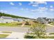 A serene neighborhood view with lush greenery and well-maintained homes under a sunny, partly cloudy sky at 587 Crossland Dr, Moncks Corner, SC 29461