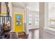 Inviting foyer features a bright yellow front door and wood floors at 587 Crossland Dr, Moncks Corner, SC 29461