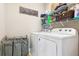 Well-organized laundry area with a washer, dryer, storage shelves and a decorative laundry sign at 587 Crossland Dr, Moncks Corner, SC 29461