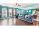 Cozy open-concept living room with plenty of seating, hardwood floors, and natural light at 587 Crossland Dr, Moncks Corner, SC 29461