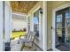 Relaxing front porch featuring a wooden rocking chair and a beadboard ceiling at 587 Crossland Dr, Moncks Corner, SC 29461