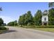Scenic community entrance with lush landscaping, mature trees, and an elegant gatehouse at 587 Crossland Dr, Moncks Corner, SC 29461
