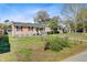Cozy one-story home with a quaint front porch in a quiet neighborhood setting at 679 Kent St, Mount Pleasant, SC 29464