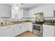 Clean kitchen featuring white cabinets, granite countertops, and stainless steel appliances at 679 Kent St, Mount Pleasant, SC 29464