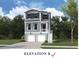Charming two-story home featuring a two-car garage, neutral siding, and a welcoming front entrance at 744 Minton Rd, Charleston, SC 29412