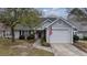 Charming home with a well-manicured lawn, attached garage, and patriotic American flag at 9080 Delancey Cir, North Charleston, SC 29406