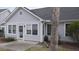 Exterior of home with a door leading to a patio area with lawn and trees at 9080 Delancey Cir, North Charleston, SC 29406