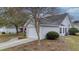 Well-maintained home with an attached garage, bay window, and mature landscaping at 9080 Delancey Cir, North Charleston, SC 29406