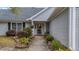 Inviting front entrance with a walkway, mature shrubs, and blooming flowers at 9080 Delancey Cir, North Charleston, SC 29406