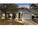 Charming single-story home featuring an attached garage, well-maintained lawn, and inviting curb appeal at 9080 Delancey Cir, North Charleston, SC 29406