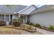 Landscaped front yard with flowering plants, bushes, and decorative lighting along the walkway at 9080 Delancey Cir, North Charleston, SC 29406