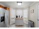 Bright kitchen featuring a refrigerator, an island with storage, and windows with white blinds for natural light at 9080 Delancey Cir, North Charleston, SC 29406