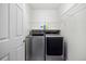 Modern laundry room with stainless steel washer and dryer and wire shelf at 9080 Delancey Cir, North Charleston, SC 29406