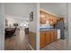 Open concept living room showcases wood floors, lots of natural light, and a view into the kitchen at 9080 Delancey Cir, North Charleston, SC 29406