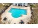 A stunning pool surrounded by an ample deck, stairs, seating, and landscaping offers a refreshing escape at 9080 Delancey Cir, North Charleston, SC 29406