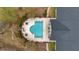 An aerial view reveals a sparkling pool next to a community building, surrounded by seating and landscaping at 9080 Delancey Cir, North Charleston, SC 29406
