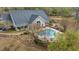 A beautiful community pool with ample seating surrounds a charming building with ample windows at 9080 Delancey Cir, North Charleston, SC 29406