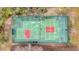 Aerial view of tennis courts with red and green surfaces surrounded by trees at 9080 Delancey Cir, North Charleston, SC 29406