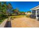 Back patio with a landscaped lawn and beautiful trees in the backyard at 9408 Harroway Rd, Summerville, SC 29485