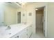 This charming bathroom has a double sink vanity, storage cabinets, and shower behind the door at 9408 Harroway Rd, Summerville, SC 29485