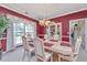 Elegant dining room with a light-colored table and a decorative china cabinet and bright window at 9408 Harroway Rd, Summerville, SC 29485