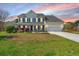Traditional two-story home with a well-maintained lawn and inviting front porch with black shutters at 9408 Harroway Rd, Summerville, SC 29485