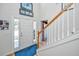 Bright foyer featuring hardwood floors, a staircase, and a front door with decorative glass at 9408 Harroway Rd, Summerville, SC 29485