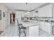 Bright kitchen with white cabinets, an island with bar seating, and modern appliances at 9408 Harroway Rd, Summerville, SC 29485