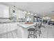 Bright kitchen boasts white cabinetry, stainless steel appliances, and center island with barstool seating at 9408 Harroway Rd, Summerville, SC 29485