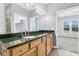 Bathroom featuring a granite countertop, wood cabinets, a sink, and a view into the bedroom at 102 Harbor Point Ct, Summerville, SC 29486