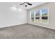 Bright bedroom featuring wood accent wall, ceiling fan, plush carpeting, and large windows offering an abundance of natural light at 102 Harbor Point Ct, Summerville, SC 29486