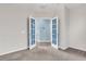 Open French doors that leading into a bedroom with gray carpet and white walls at 102 Harbor Point Ct, Summerville, SC 29486