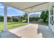 A covered patio featuring a ceiling fan overlooks the lush greenery of the backyard at 102 Harbor Point Ct, Summerville, SC 29486