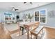 Open concept dining room with wood-look flooring, large window, and seating for four at 102 Harbor Point Ct, Summerville, SC 29486