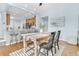 Open concept dining room with wood-look flooring and seating for four open to kitchen at 102 Harbor Point Ct, Summerville, SC 29486