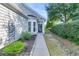 The front entryway showcases well-maintained landscaping and a clear path to a covered front door and sidelight window at 102 Harbor Point Ct, Summerville, SC 29486
