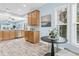 Bright kitchen with light brown cabinets, stainless steel appliances, hardwood-style floors, and a view of a dining area at 102 Harbor Point Ct, Summerville, SC 29486