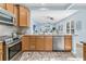 Modern kitchen overlooking a living room with stainless steel appliances, light brown cabinets, and hardwood style flooring at 102 Harbor Point Ct, Summerville, SC 29486
