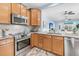 Modern kitchen with stainless steel appliances, light brown cabinetry, and an island overlooking an open living space at 102 Harbor Point Ct, Summerville, SC 29486