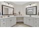 Elegant bathroom boasting dual vanities, white cabinetry and stylish mirrors at 105 Bluff Isle Ct, Summerville, SC 29486