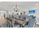 Dining room boasts views to the living area and kitchen, featuring a modern chandelier at 105 Bluff Isle Ct, Summerville, SC 29486