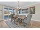 Bright dining room showcases stylish artwork, a dining set for six, and sliding door access to the outdoors at 105 Bluff Isle Ct, Summerville, SC 29486