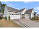 Home with a three-car garage and well-maintained landscaping at 105 Bluff Isle Ct, Summerville, SC 29486